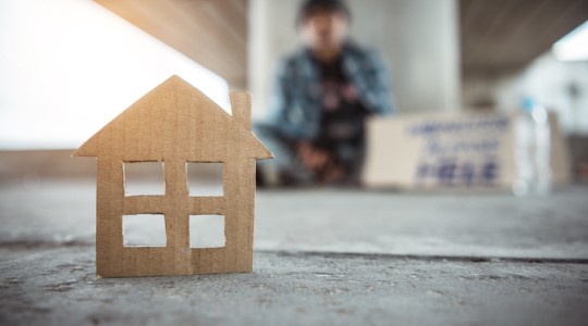 A cardboard cutout house representing resources for homeless residents.